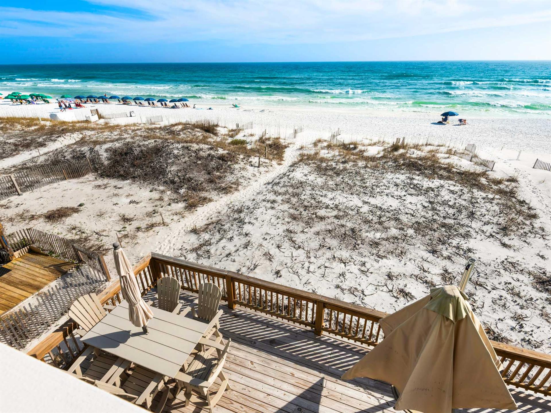Beachfront property with private deck offering direct access to pristine Gulf waters and white sand dunes.