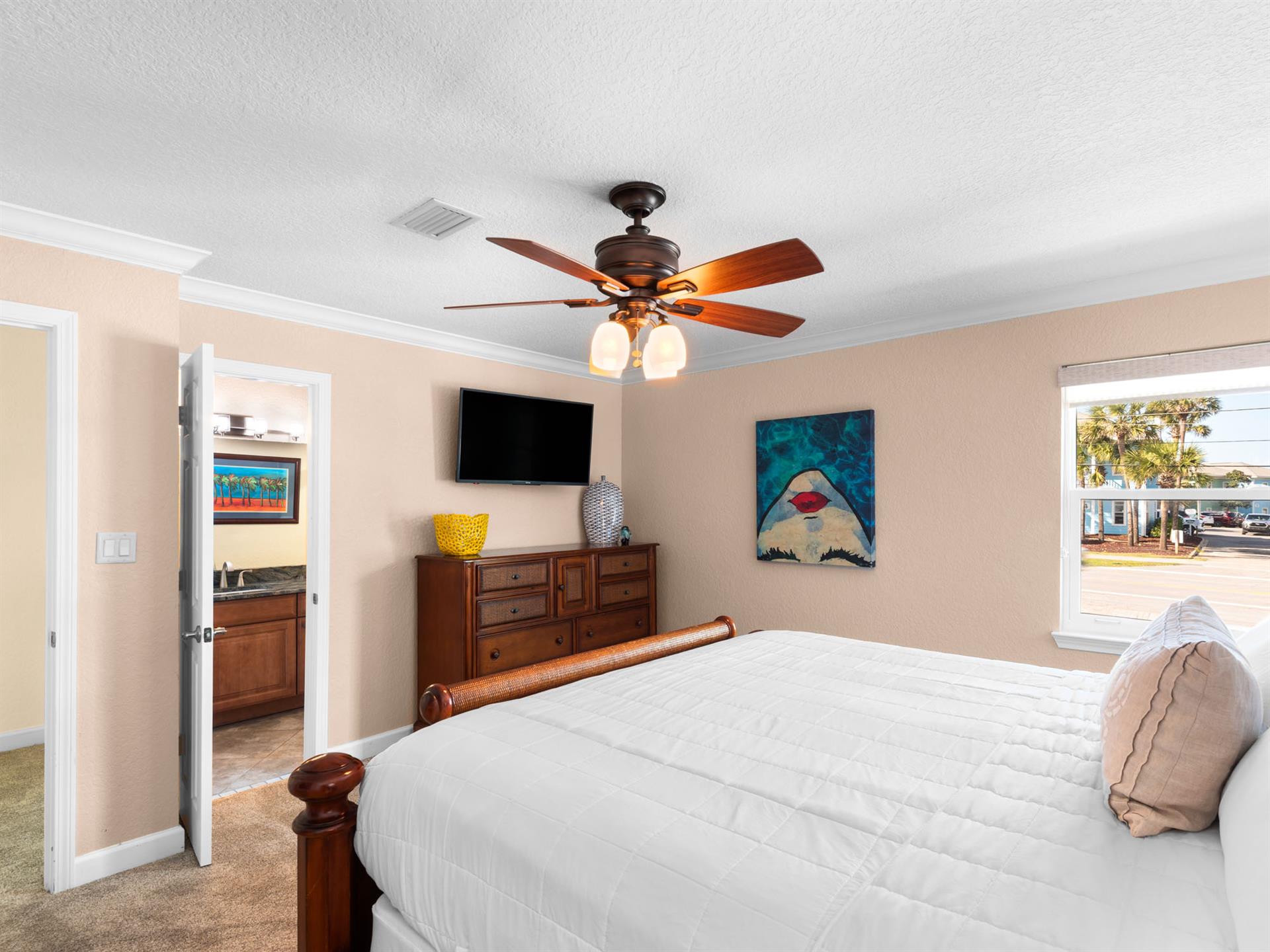 Drift off to sleep inthe spacious Guest bedroom with tropical artwork creating a coastal sanctuary.