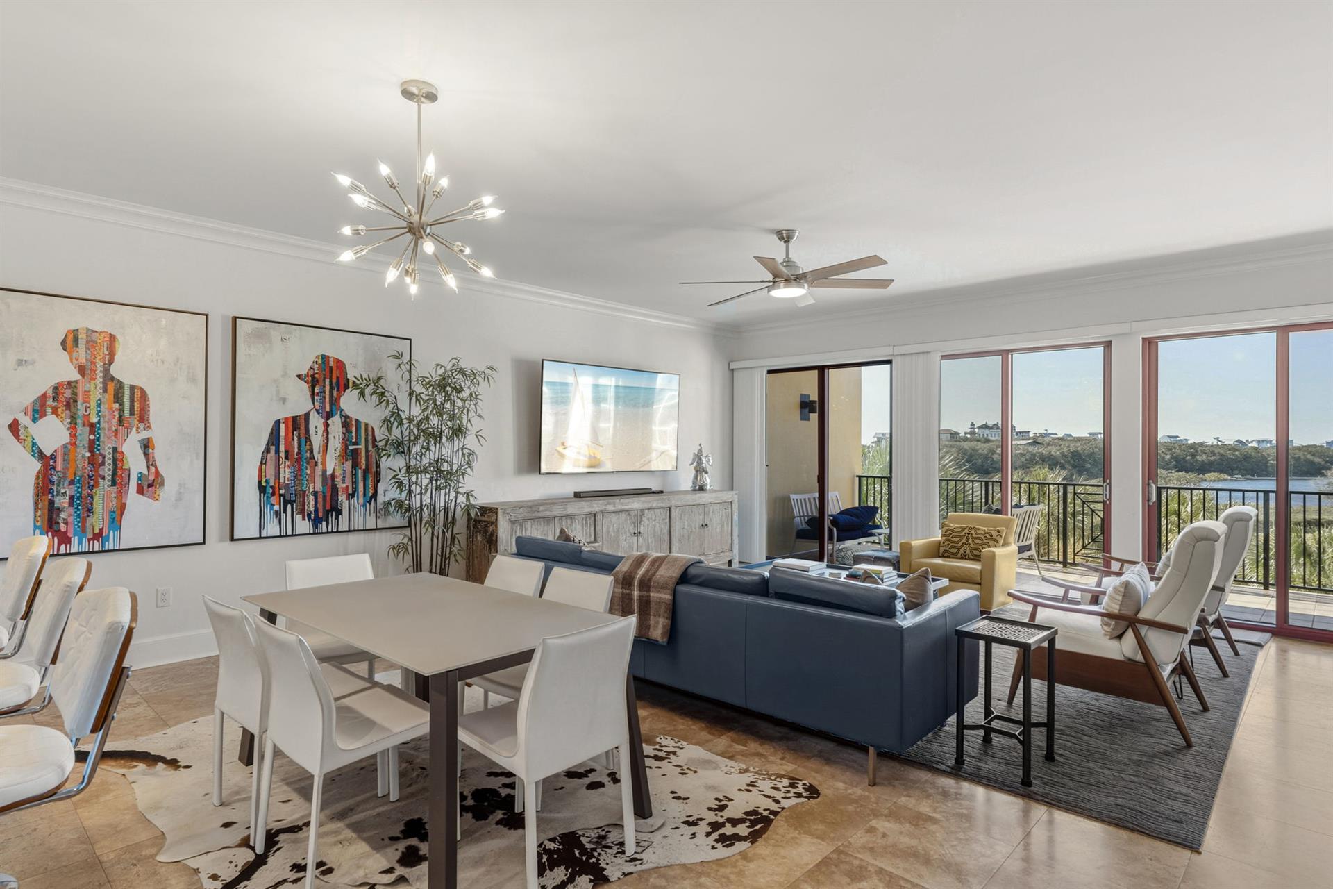 Unwind in this stylish living space where modern art meets comfort, with expansive windows framing peaceful views for your perfect getaway.