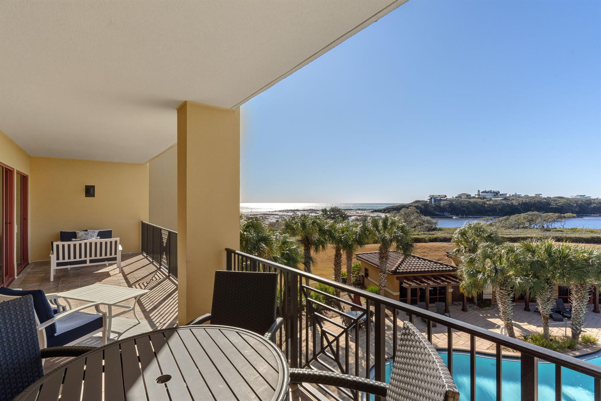 Private balcony with stunning views of the pool and coastline beyond, perfect for morning coffee or evening relaxation.