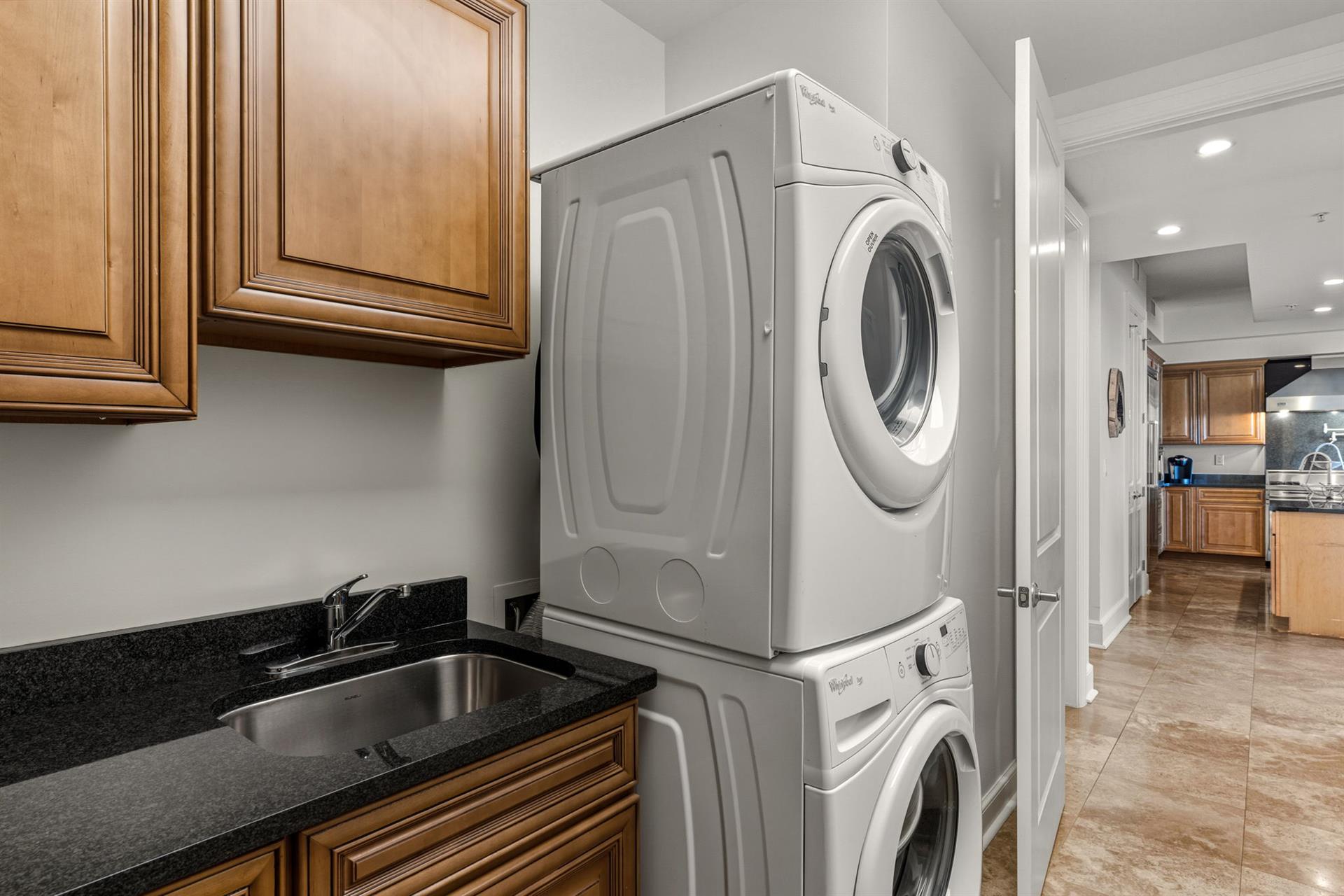 Private laundry area makes staying effortless with fullsize washer and dryer plus convenient sink for delicate care.