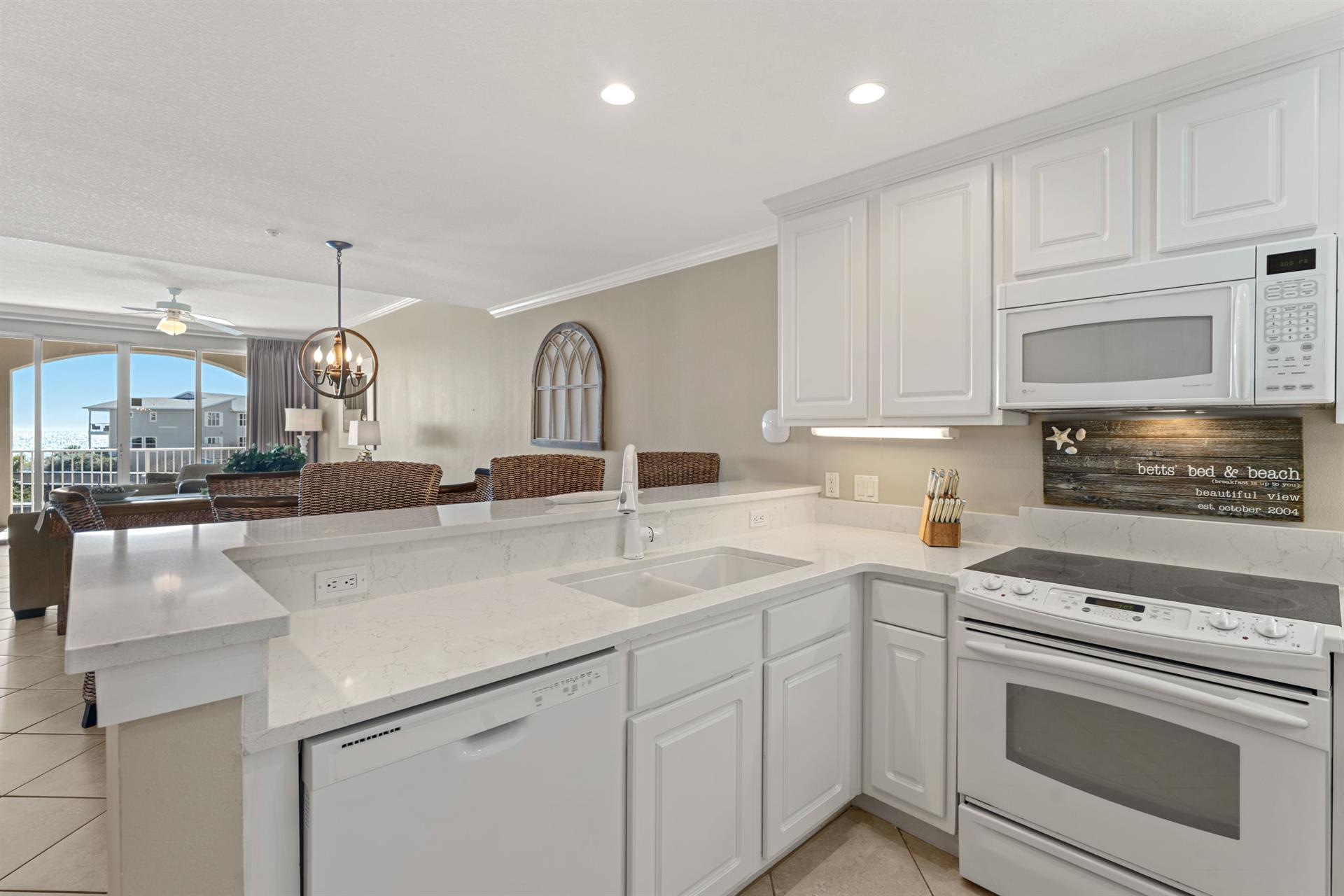 The kitchen features stainless appliances, perfect for preparing meals while enjoying the open layout.