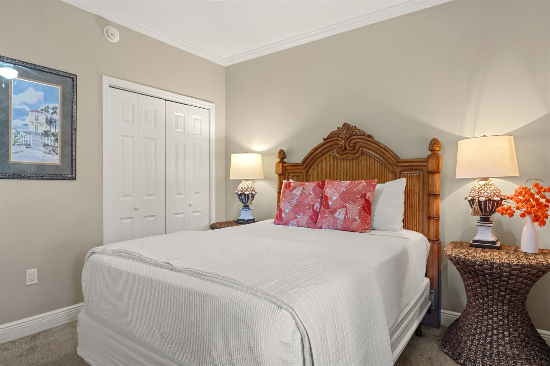 Sink into crisp white linens and tropical comfort in the peaceful bedroom retreat, complete with charming wicker touches and warm coastal lighting.