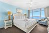 Bedrooom1 Wake up to breathtaking ocean views from your comfortable bed. Soft blue walls and coastal furnishings create a serene retreat.