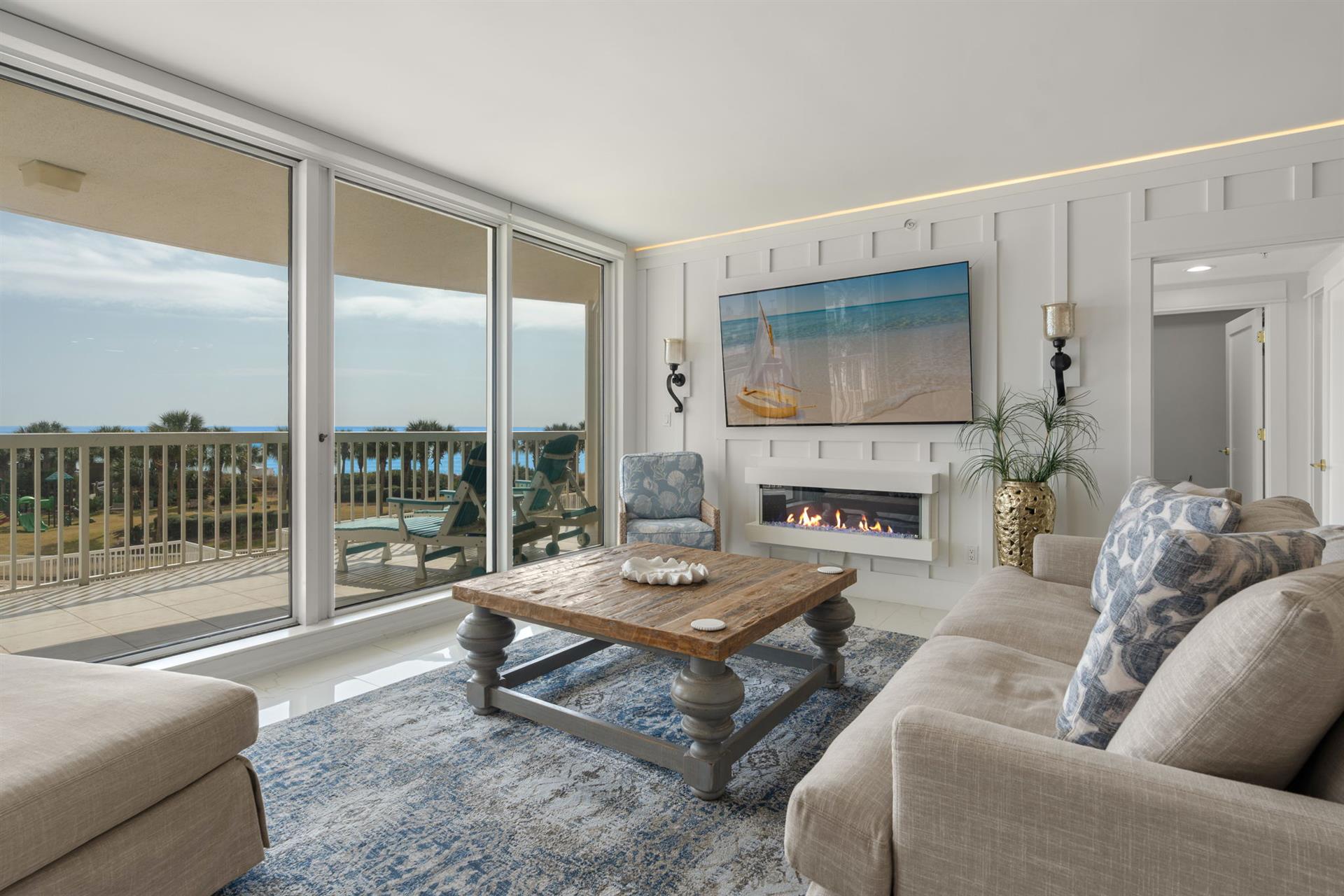 Unwind in your elegant living space featuring floortoceiling windows, cozy fireplace, and stunning coastal views from your private balcony.