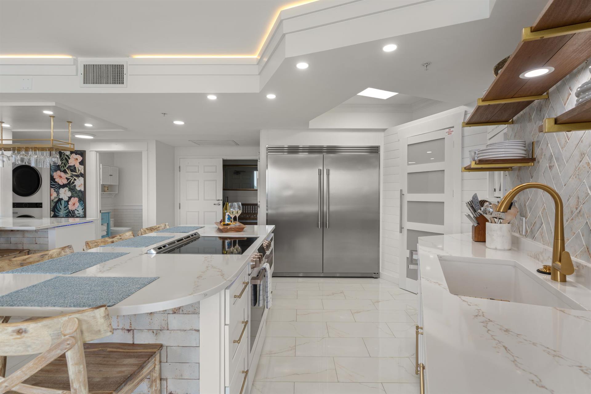 Your gourmet kitchen awaits with marble counters, gold fixtures, and professional appliances for culinary adventures.