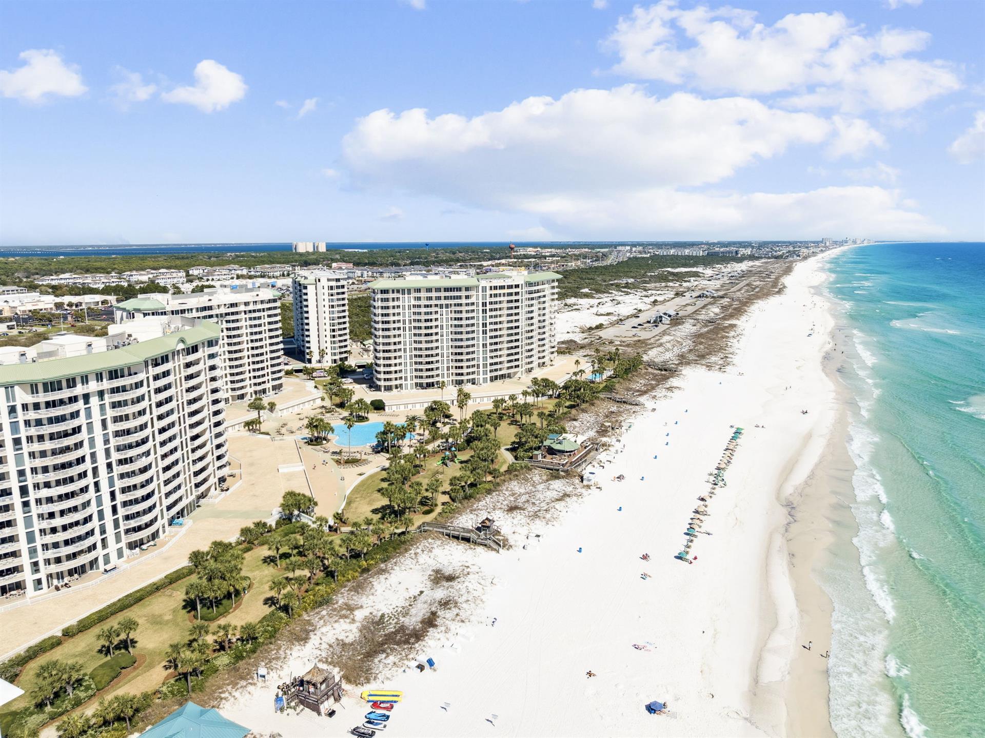 Beachfront condominium towers overlook pristine white sand beaches and crystalclear turquoise waters along this stunning coastal destination.