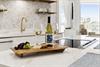 Unwind with wine and cheese in your elegant kitchen, featuring marble counters and gold fixtures for memorable evenings.