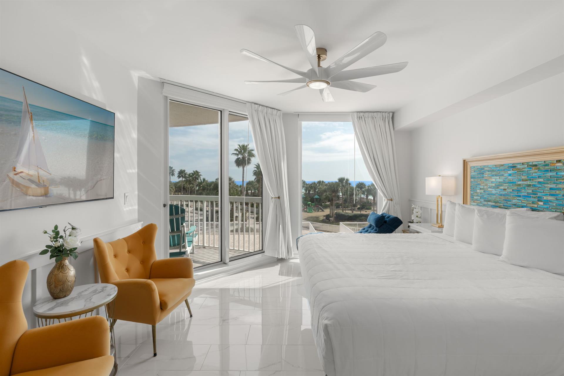 Wake up to tropical views from your bright bedroom with palm trees swaying beyond your private balcony.