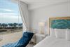 Wake up to stunning ocean views from your luxurious bedroom, where crisp white linens meet coastalinspired décor for the perfect seaside escape.