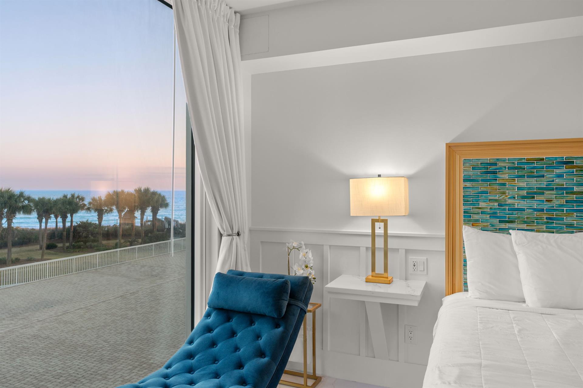 Wake up to stunning ocean views from your comfortable bed, where white linens and coastalinspired décor create your perfect beachside retreat.