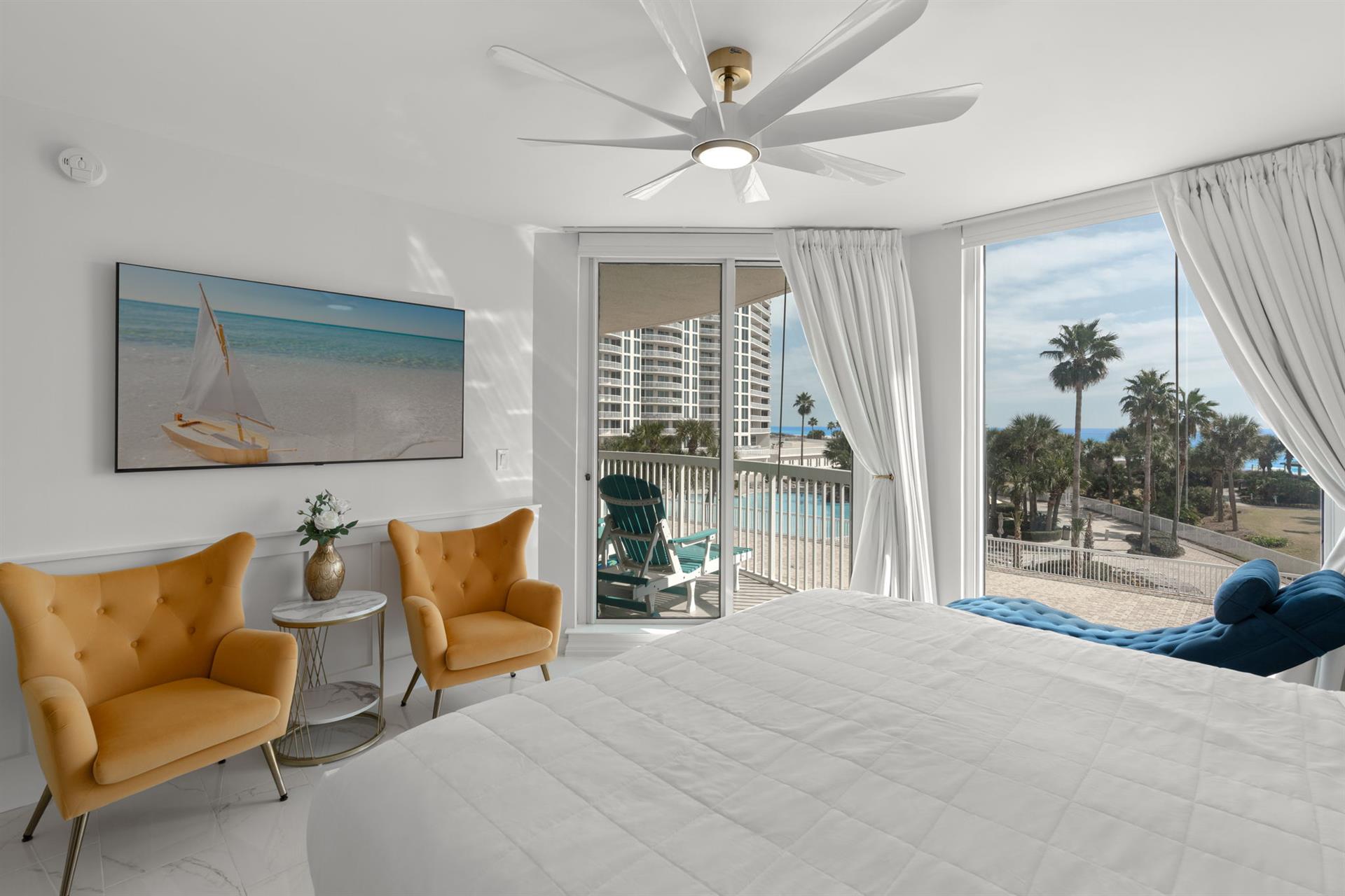 Wake up to breathtaking ocean views from your stylish bedroom, where comfort meets coastal elegance with plush seating and private balcony access.
