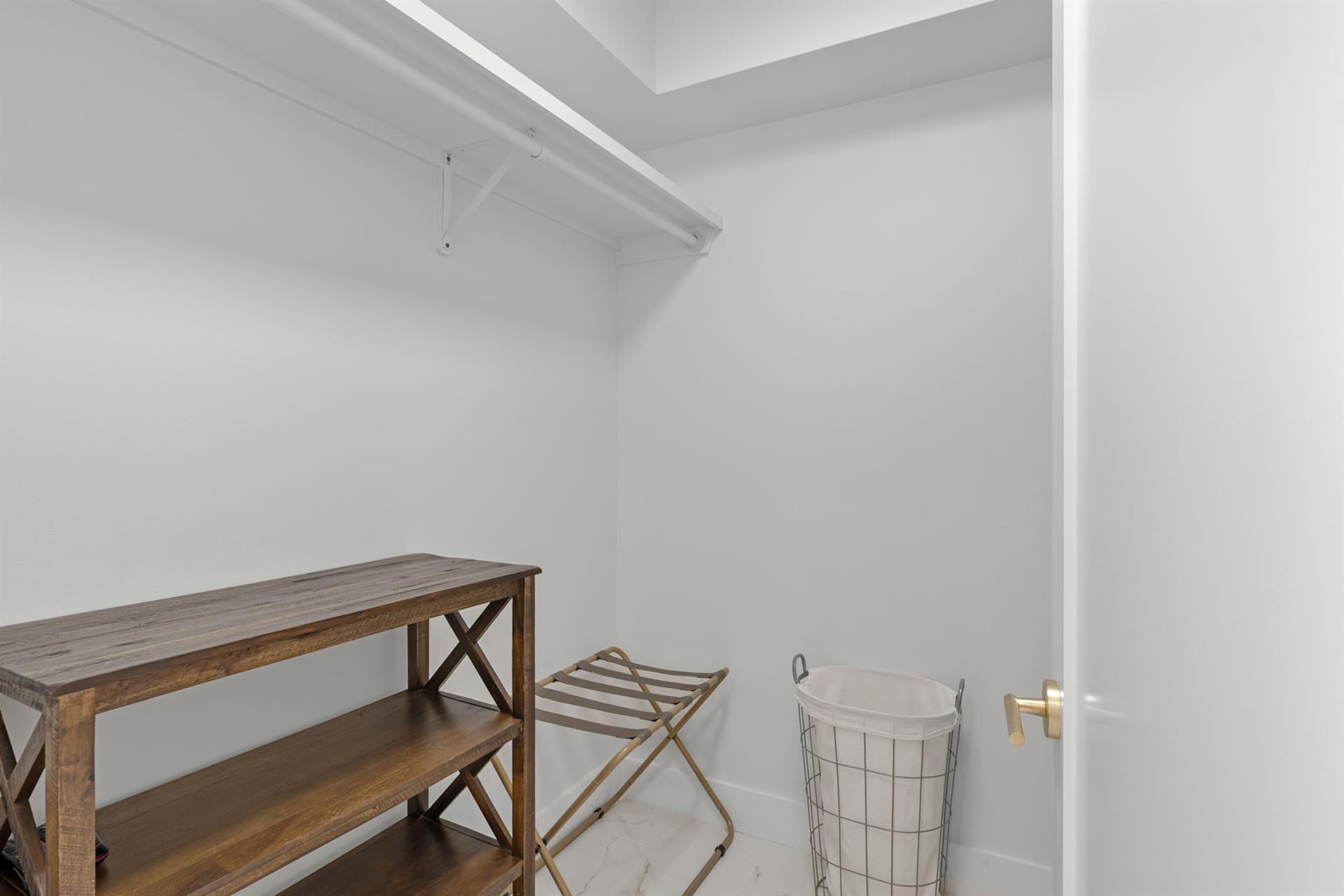 Your walkin closet features builtin shelving and hanging rods, plus a handy folding table for organizing your wardrobe effortlessly.