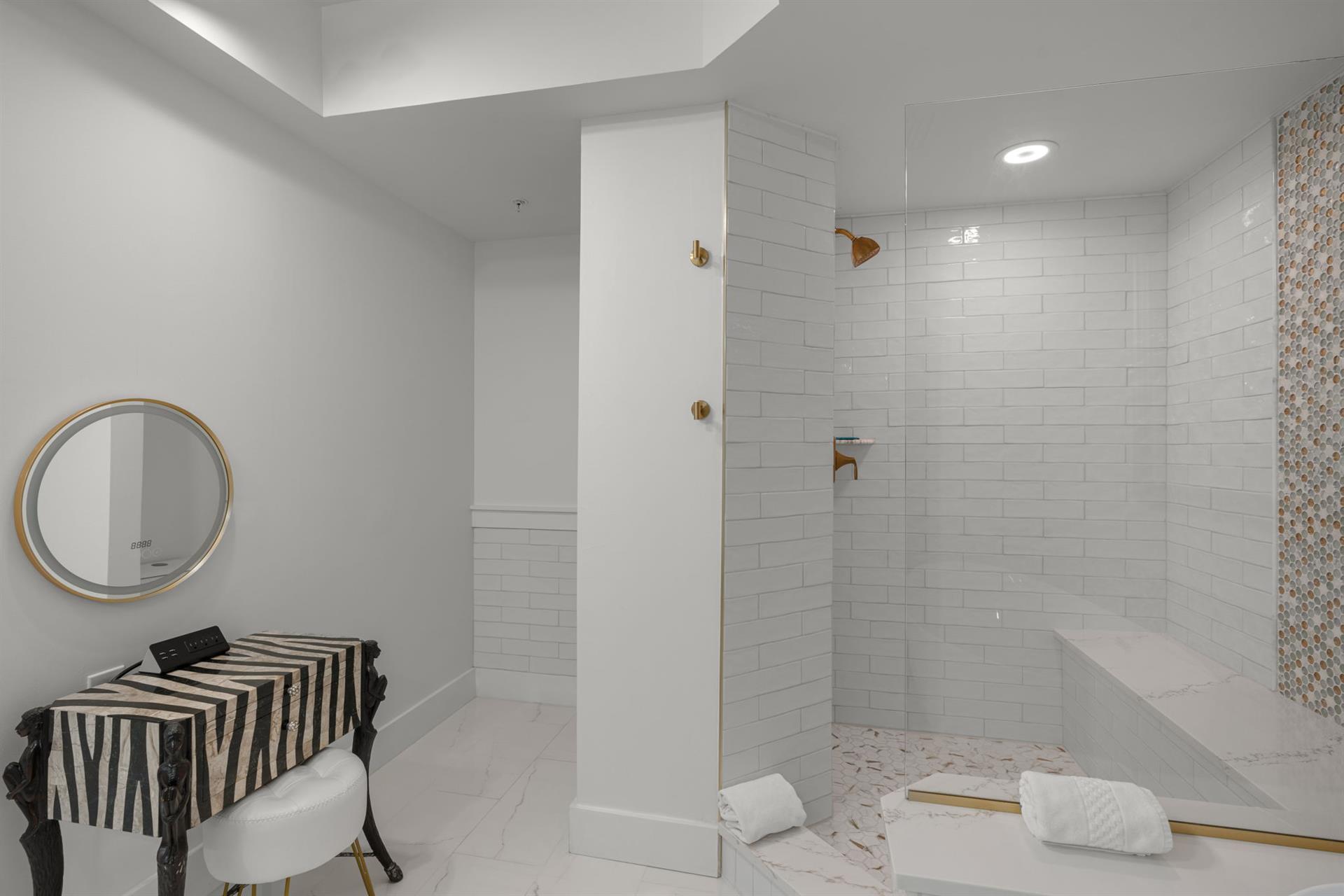 Step into your spalike bathroom sanctuary with marble floors, subway tile shower, and golden fixtures for pure relaxation.