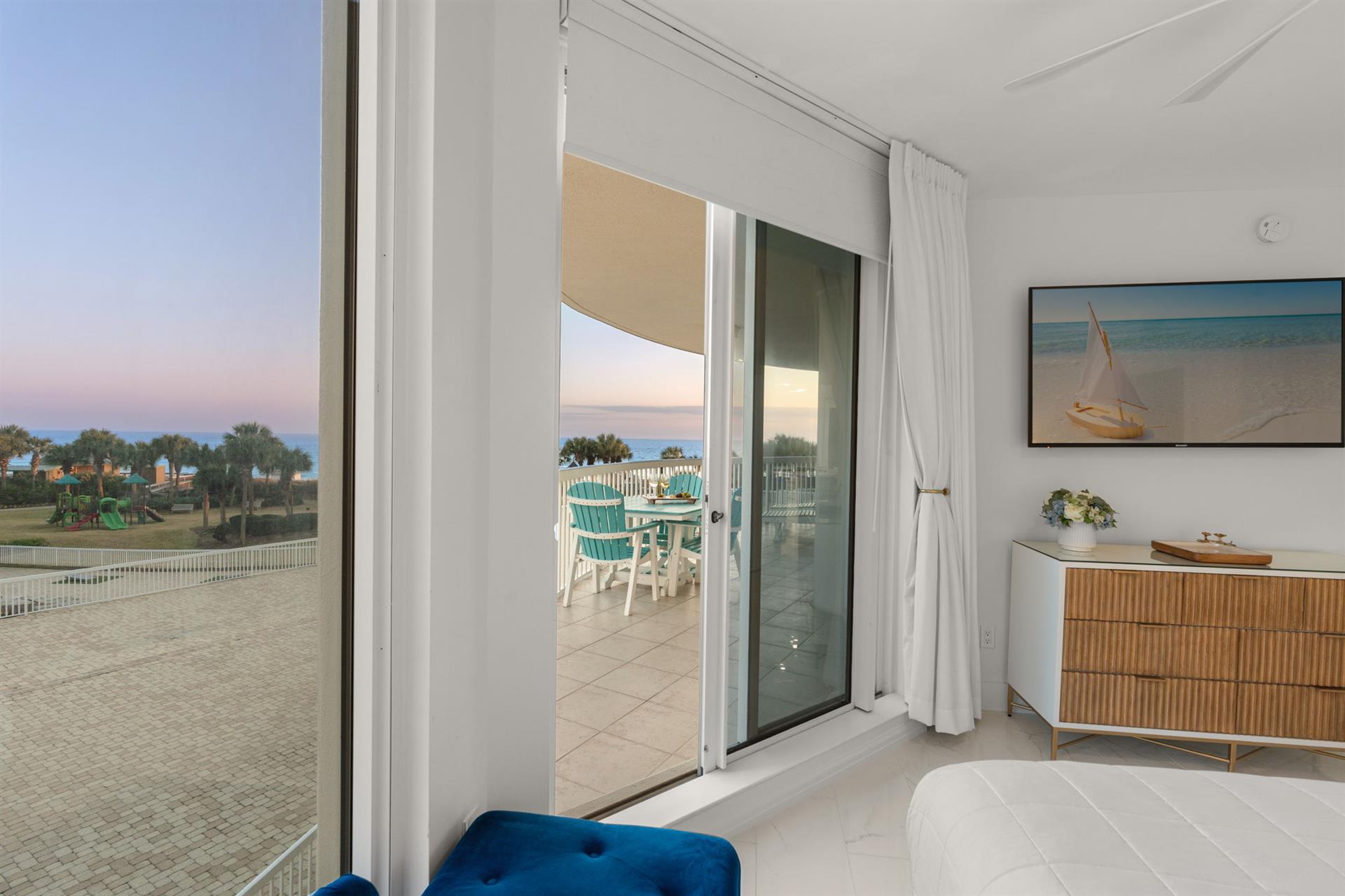 Wake up to stunning sunrise views from your private balcony, where turquoise chairs await your morning coffee moments.