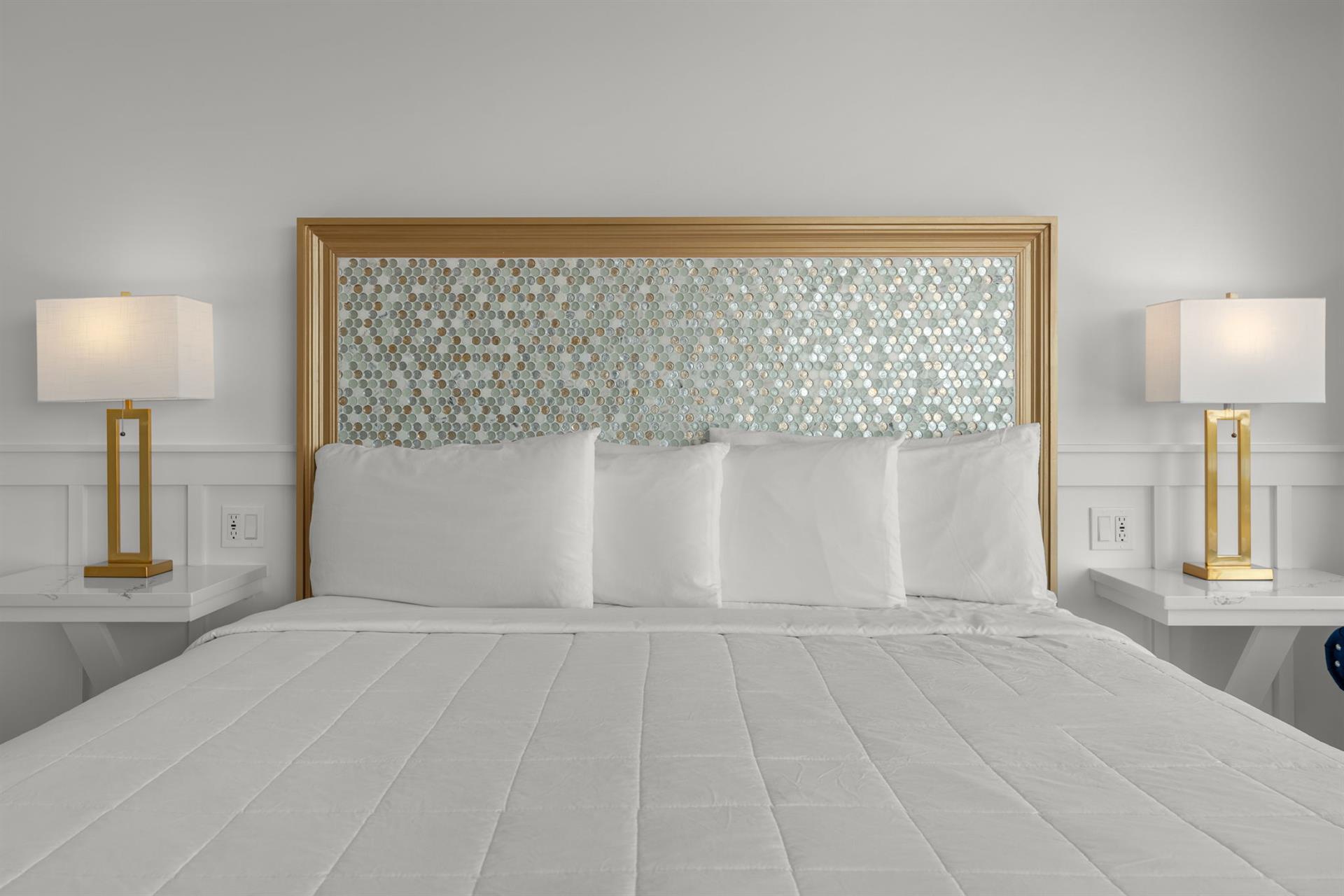 Sink into luxurious comfort with plush pillows and elegant gold accents that create your perfect retreat.