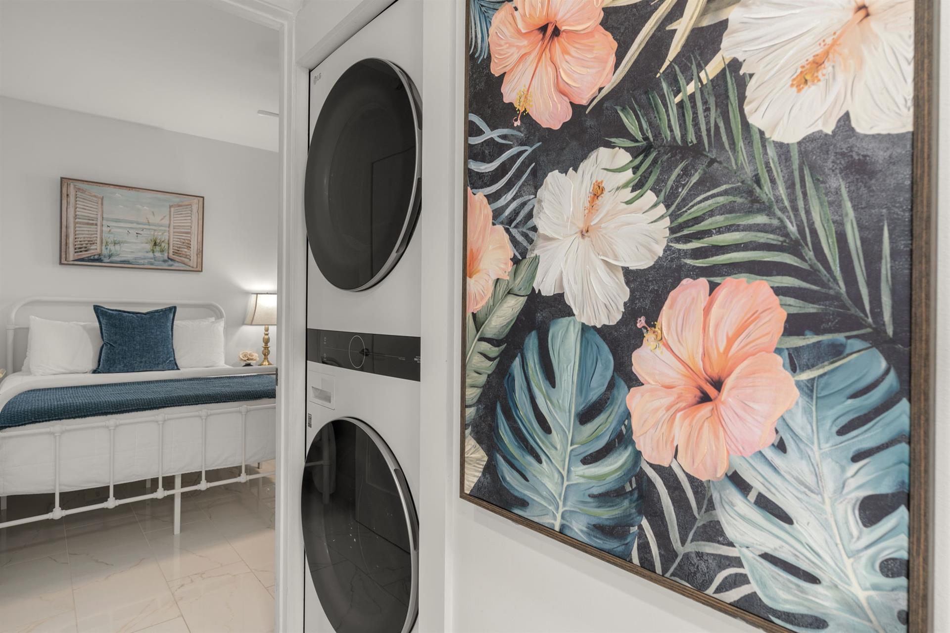 Your own private laundry room features a tropical floral accent wall, making chores feel like a breeze during your stay.