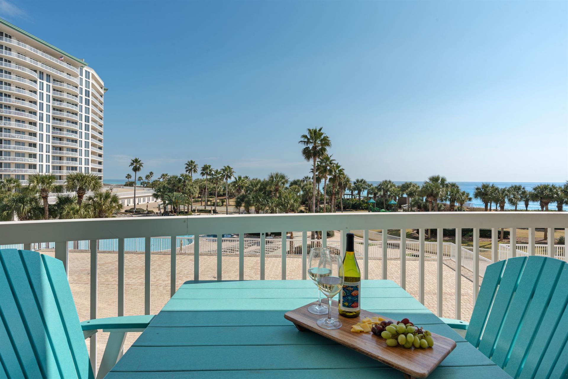 Sip wine and savor moments on your private balcony with stunning beach views and swaying palms.