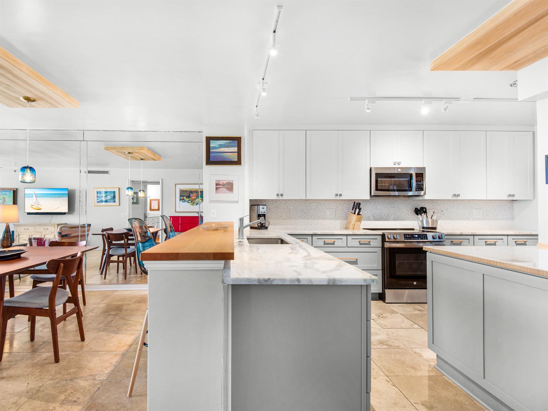The spacious kitchen island becomes the heart of memorable meals, with gleaming countertops and modern appliances ready for culinary adventures.