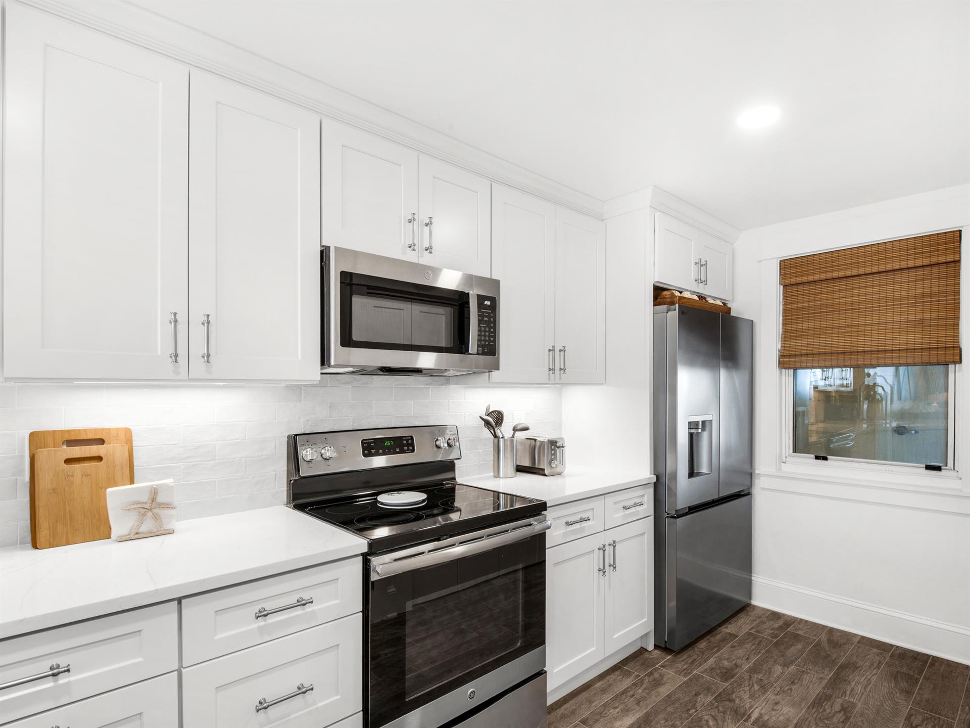 Your bright, fullyequipped kitchen features crisp white cabinetry and stainless steel appliances, ready for homecooked meals.