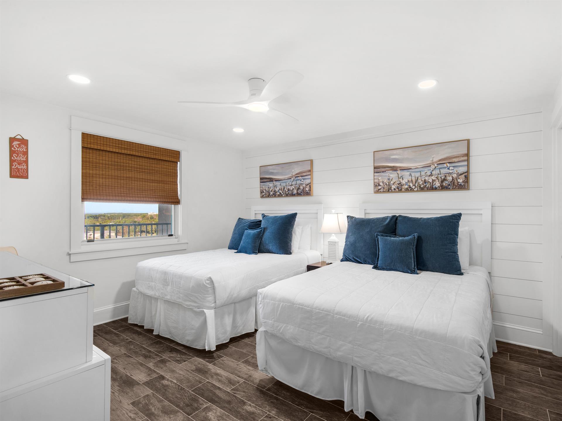 Bedroom 2  Relax in your bright twin bedroom with crisp white linens and plush navy pillows that invite peaceful sleep.