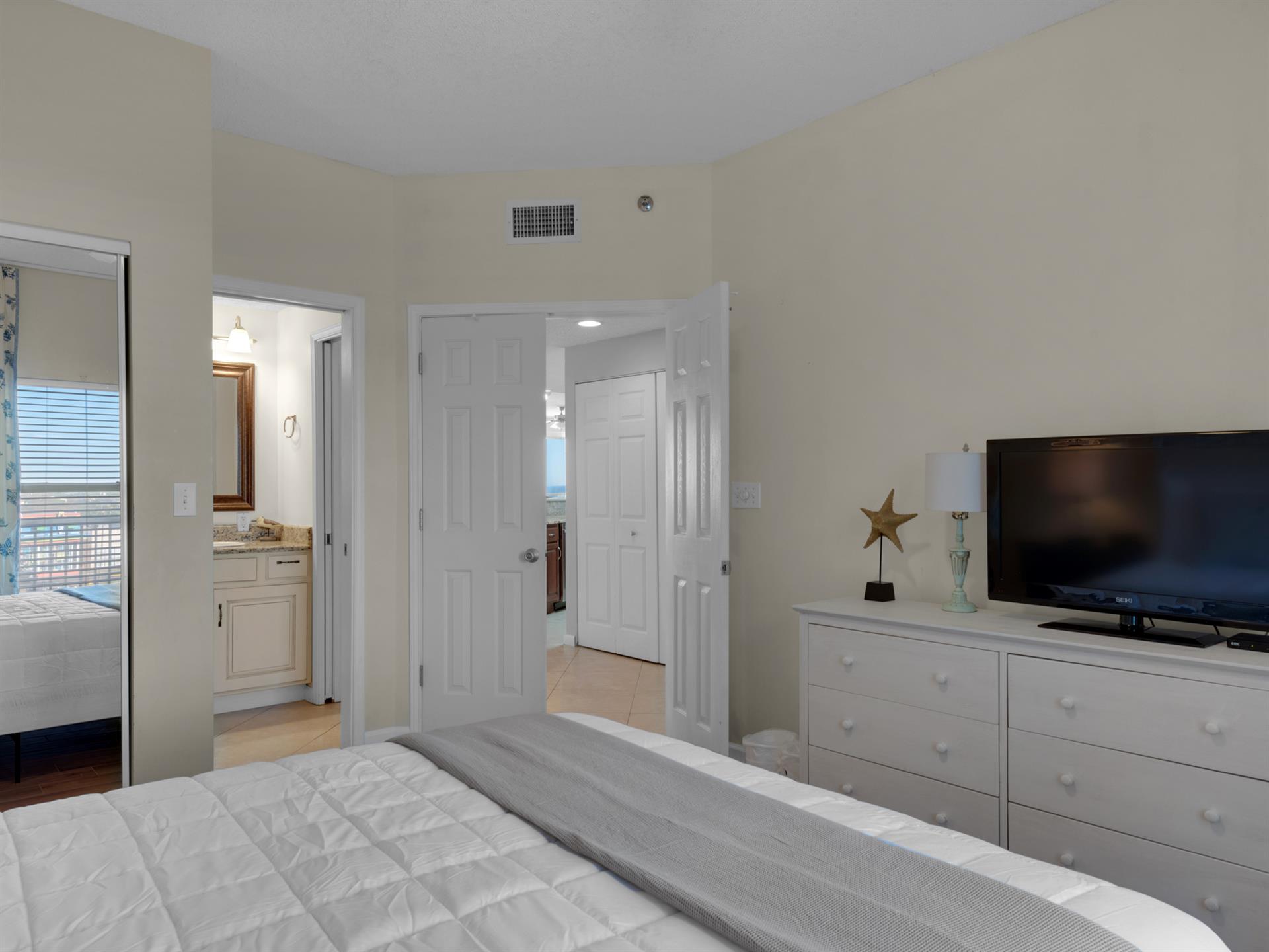 Your comfortable bedroom features a flatscreen TV and thoughtful touches, with easy access to a private bathroom for your convenience.