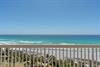 Breathtaking beachfront balcony view with pristine white sand and turquoise Gulf waters stretching endlessly before you.