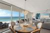 Wake up to stunning ocean views through floortoceiling windows in your bright, elegant dining space with direct beach access.