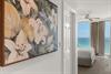 Youll be greeted by stunning floral artwork as you enter your oceanfront bedroom, where turquoise waters stretch endlessly beyond your private balcony.