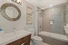 Unwind in your beautifully appointed bathroom featuring elegant mosaic details and a relaxing tub for your perfect getaway.