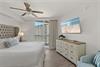 Unwind in your serene bedroom with coastal décor, city views, and gentle ceiling fan breezes to lull you to sleep.