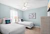 Bedroom 3  Drift off peacefully in your serene twin bedroom with soft blue walls and coastal charm.