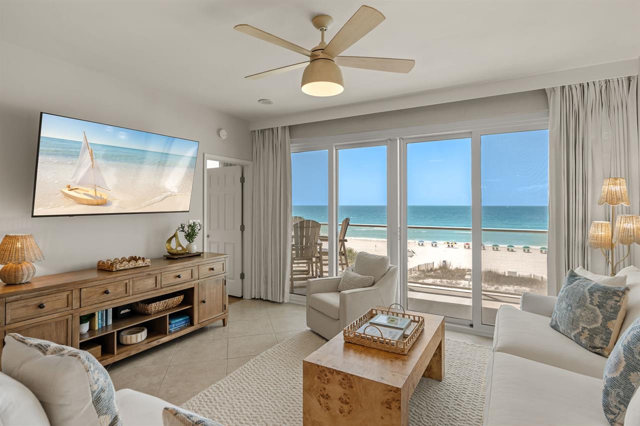 Unwind in your beachfront living room where panoramic ocean views meet coastal comfort through floortoceiling windows.