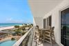 Spectacular beachfront balcony featuring pristine white sand, crystalclear waters, and tropical palms creating your perfect coastal retreat.