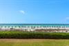Pristine white sand beach with emerald waters stretches beyond the property grounds, offering direct beachfront access.