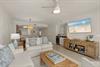 Relax in your coastalinspired living space where soft blue accents and beach artwork create a serene atmosphere.