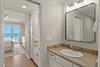 Step into your elegantly appointed bathroom where stunning ocean views greet you from the adjoining bedroom.
