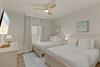 Bedroom 2 where youll wake up refreshed in this coastalthemed bedroom with two comfortable beds.