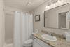 Step into your sparkling clean bathroom featuring granite countertops, elegant lighting, and fresh towels waiting for you.