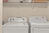 Your dedicated laundry space keeps your wardrobe fresh throughout your stay, with convenient wire shelving for storage above.