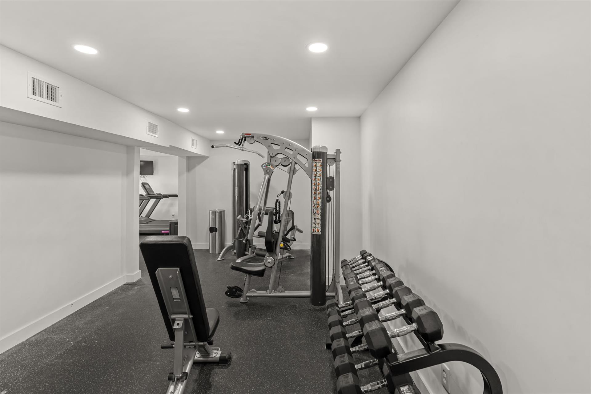 Your private fitness suite awaits with premium equipment, from free weights to multistation machines, all in a clean, welllit space.