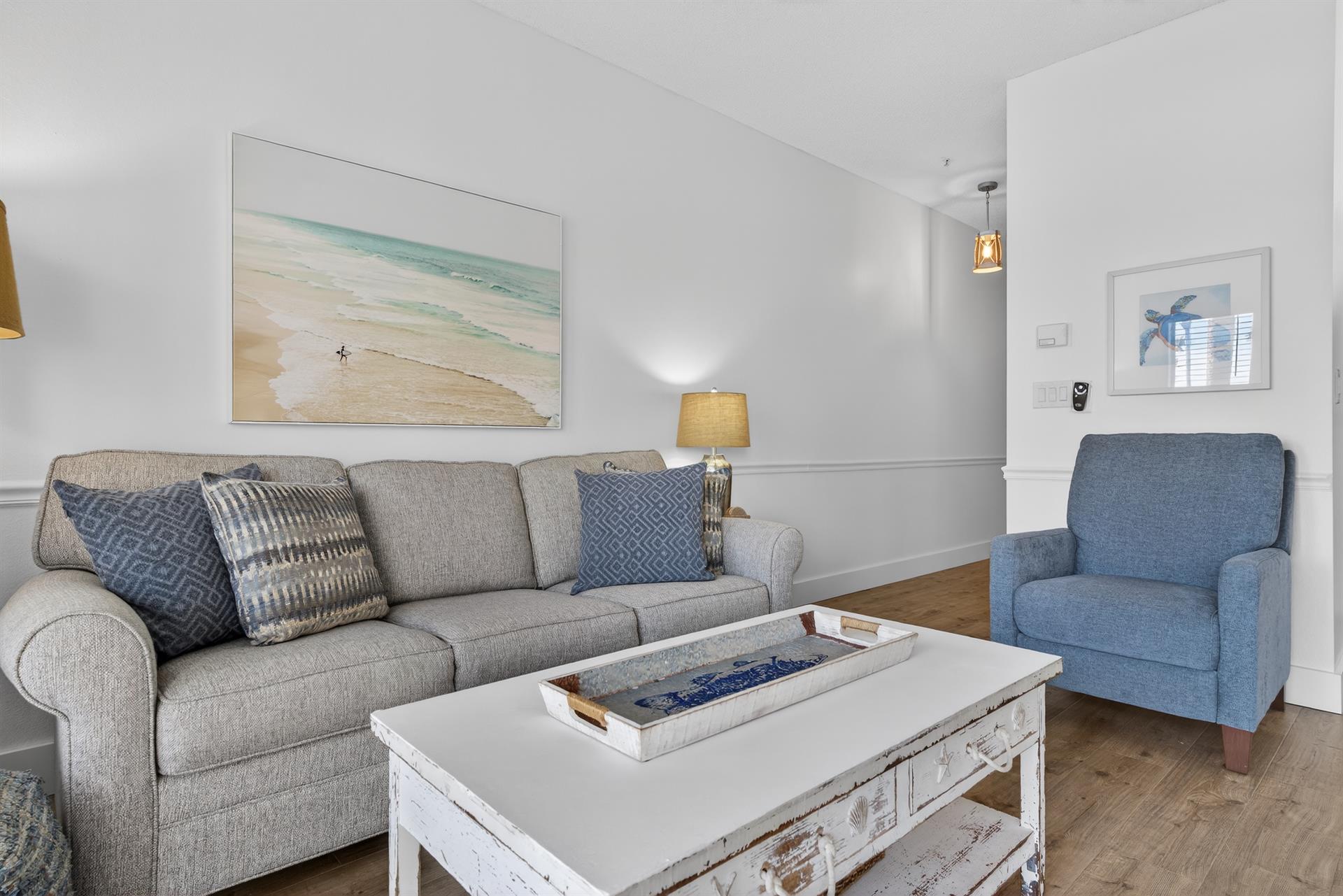 Unwind in your coastalinspired living room with plush seating and soothing beach artwork that brings ocean vibes indoors.
