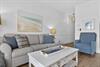 Unwind in your coastalinspired living room with plush seating and soothing beach artwork that brings ocean vibes indoors.