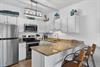 Your fully equipped kitchen awaits with granite counters, stainless appliances, and coastal charm—perfect for preparing meals in style.
