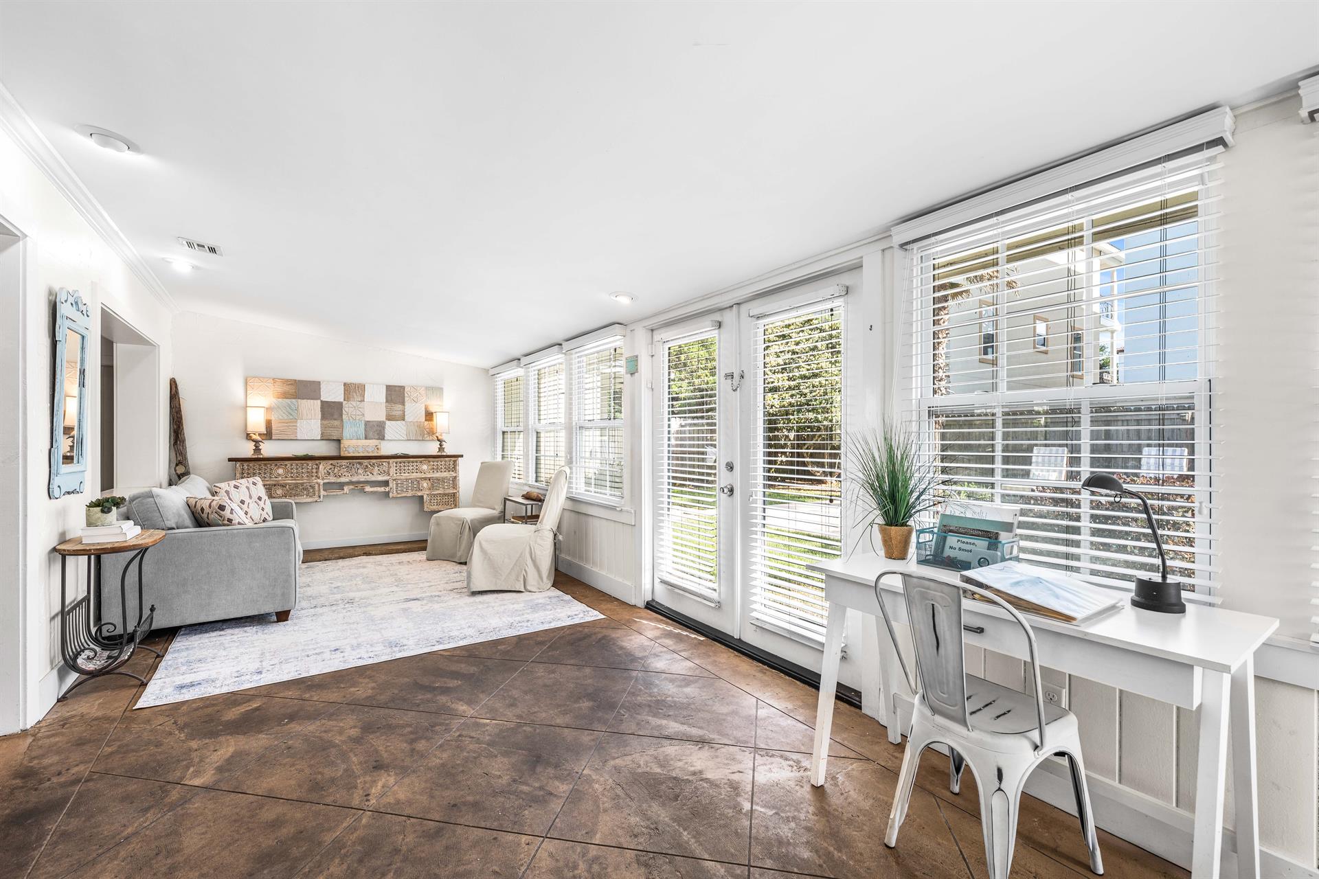 A traditional Florida Room in Seabreeze with a sleeper sofa, bar cabinet, a desk,  access to the pool area through French doors. safety alarm
Fully stocked Beach Gear closet