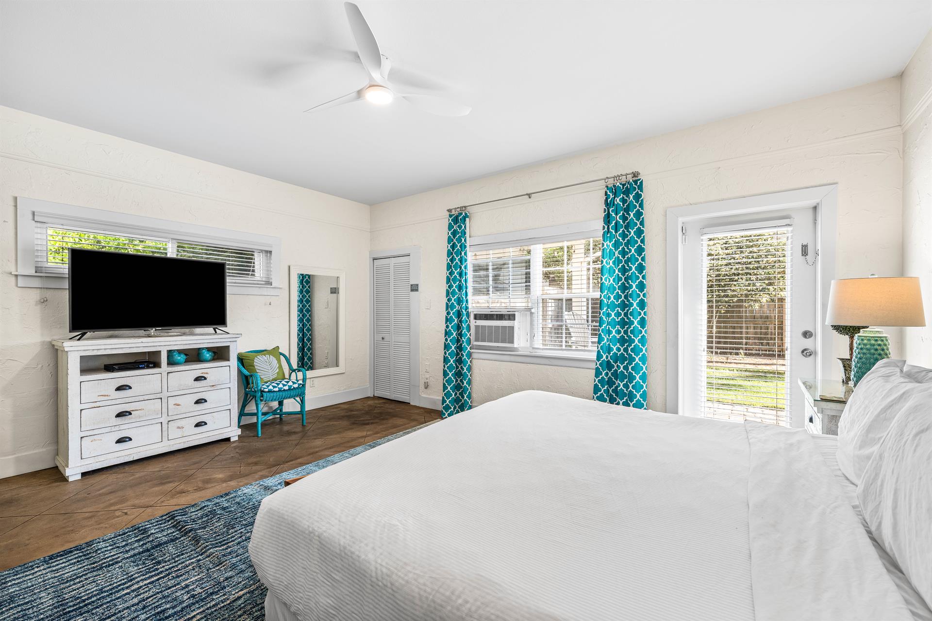 3rd Bedroom is the primary suite on the east end with a king bed, 45 TV,  walkin closet, ensuite full bathroom with a bathtubshower combination, and views of the pool area  door leading out to the