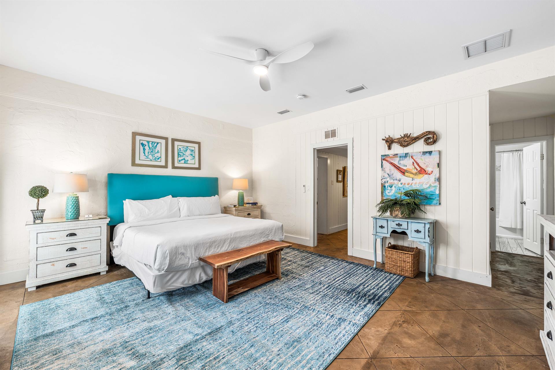 3rd Bedroom is the primary suite on the east end with a king bed, 45 TV,  walkin closet, ensuite full bathroom with a bathtubshower combination, and views of the pool area  door leading out to the