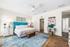 3rd Bedroom is the primary suite on the east end with a king bed, 45 TV,  walkin closet, ensuite full bathroom with a bathtubshower combination, and views of the pool area  door leading out to the
