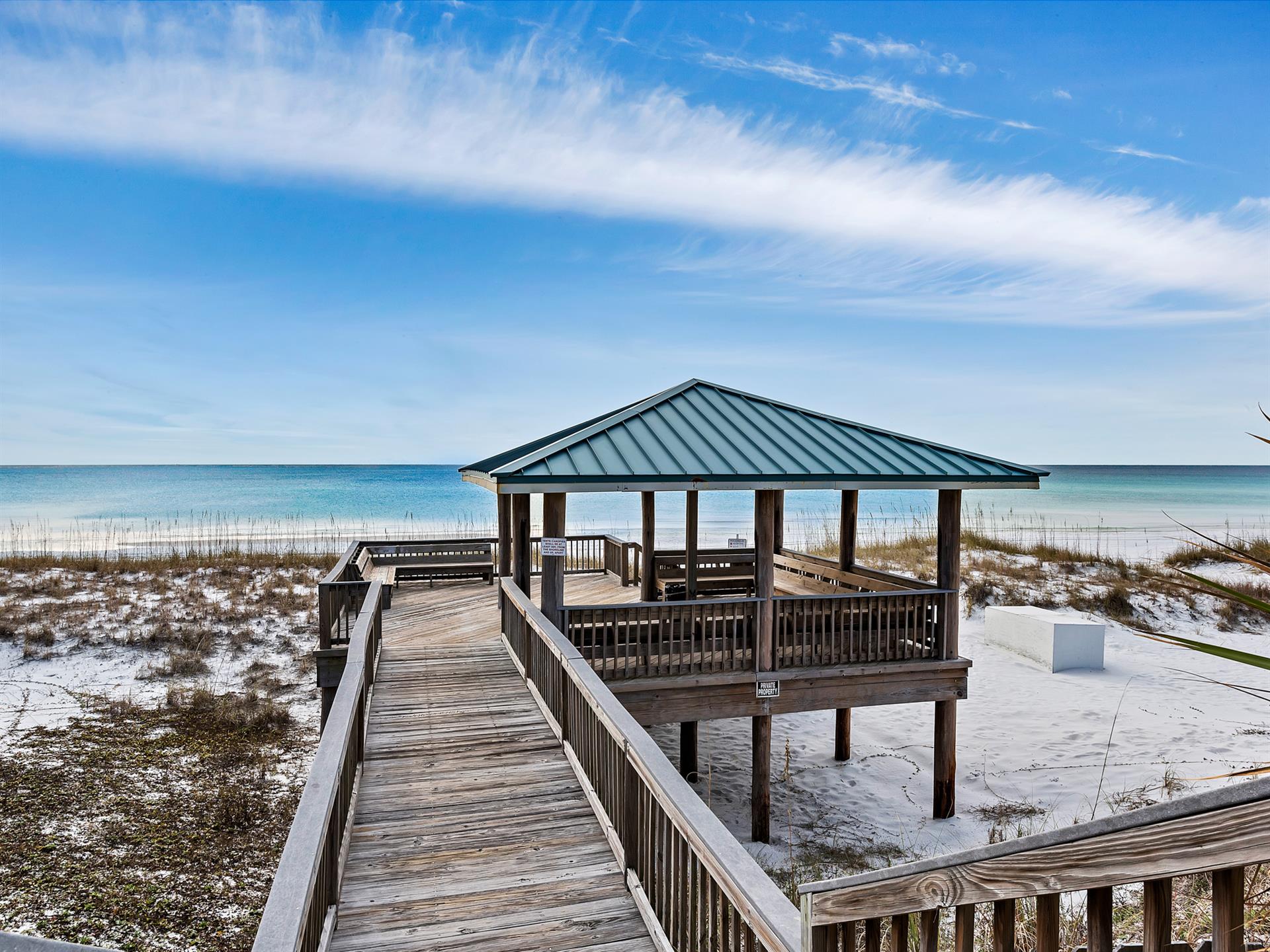 Elevated beachside pavilion with stunning Gulf Coast views and pristine white sand stretching to turquoise waters.
