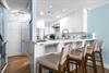 The modern kitchen features a breakfast bar perfect for morning coffee or casual meals.
